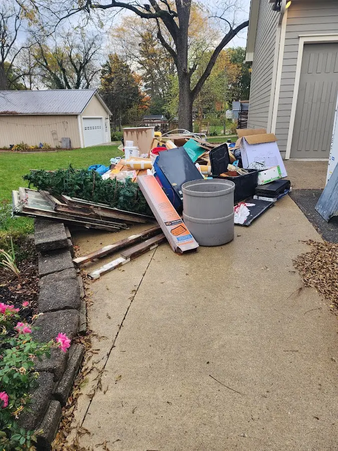 Dumpster being loaded with debris for Roofing Dumpster Rental in Saugus